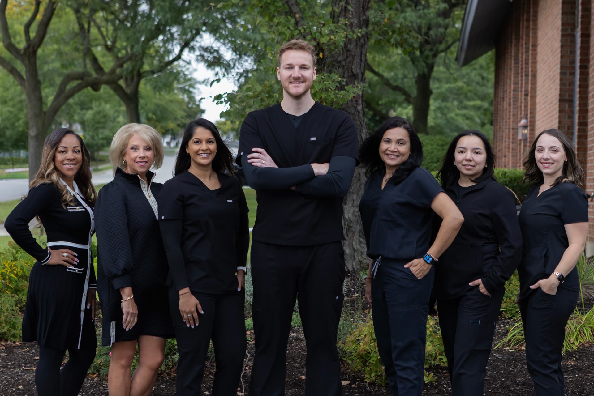 The Renew Dental Loft team standing outside in front of a brick building
